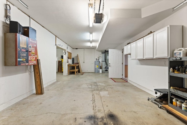 garage featuring a garage door opener and water heater