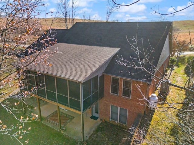 back of house with a sunroom and a patio area