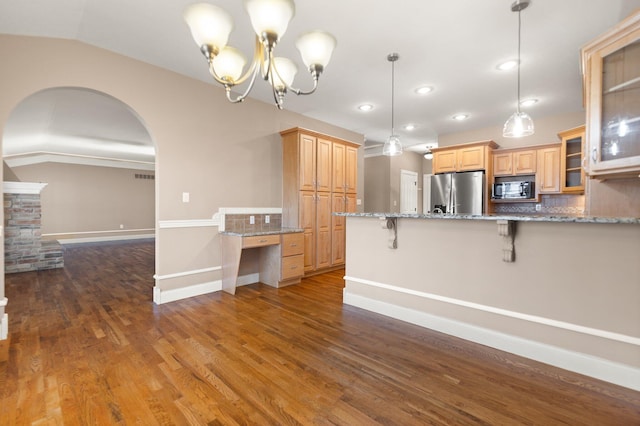 kitchen with lofted ceiling, decorative light fixtures, black microwave, decorative backsplash, and stainless steel fridge with ice dispenser