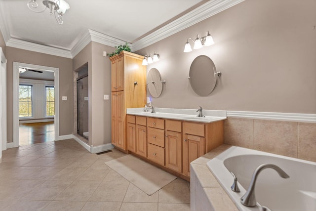 bathroom featuring crown molding, tile patterned flooring, shower with separate bathtub, and vanity