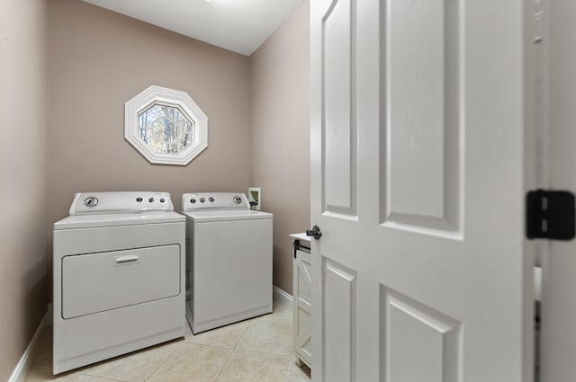 washroom with washing machine and clothes dryer and light tile patterned flooring