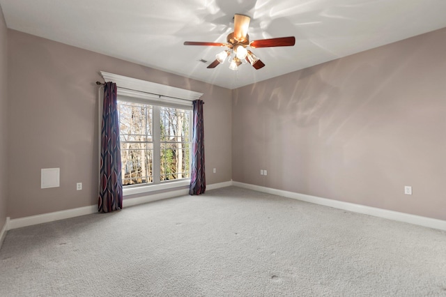 empty room with ceiling fan and carpet flooring