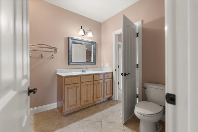 bathroom featuring vanity, toilet, and tile patterned floors