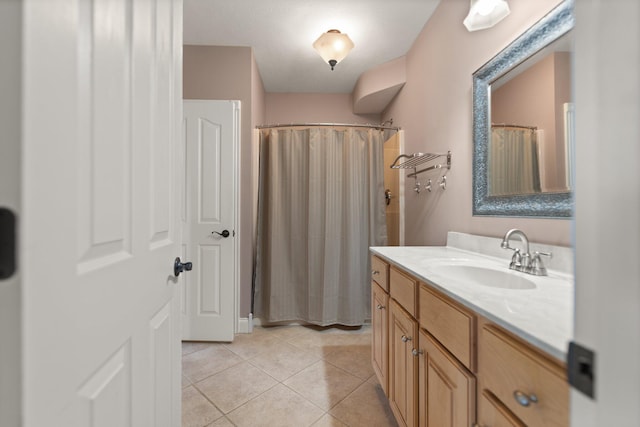 bathroom with tile patterned flooring, a shower with shower curtain, and vanity