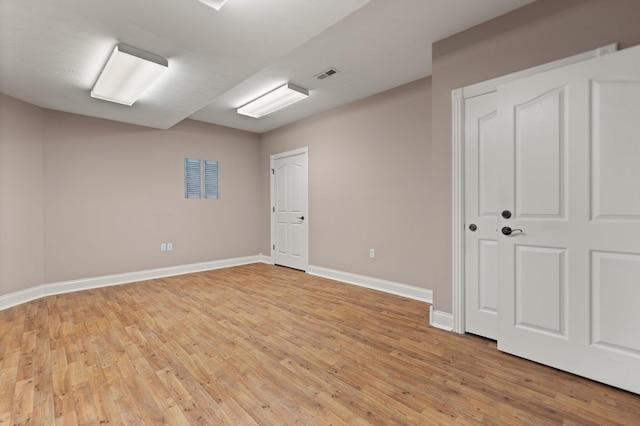 spare room featuring light hardwood / wood-style flooring