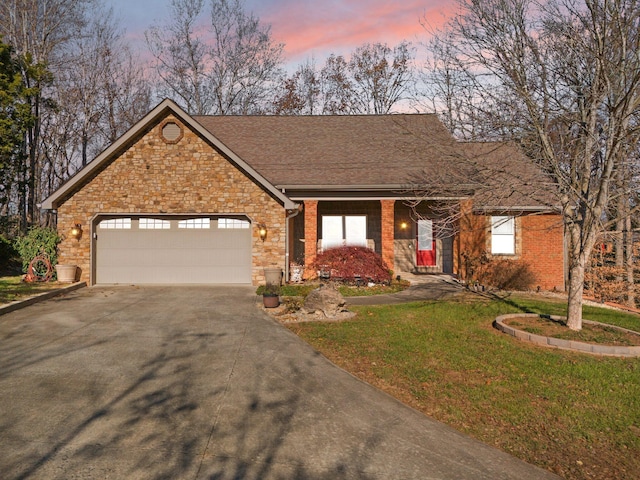 ranch-style home with a yard and a garage