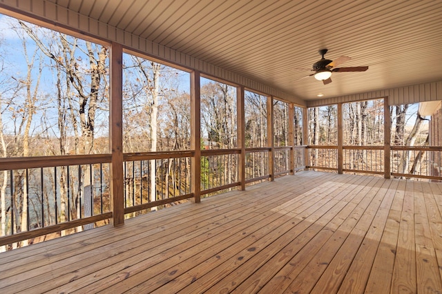 unfurnished sunroom featuring ceiling fan