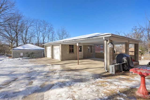 exterior space featuring a garage and an outdoor structure