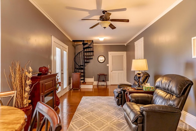 living area with ceiling fan, crown molding, and hardwood / wood-style floors