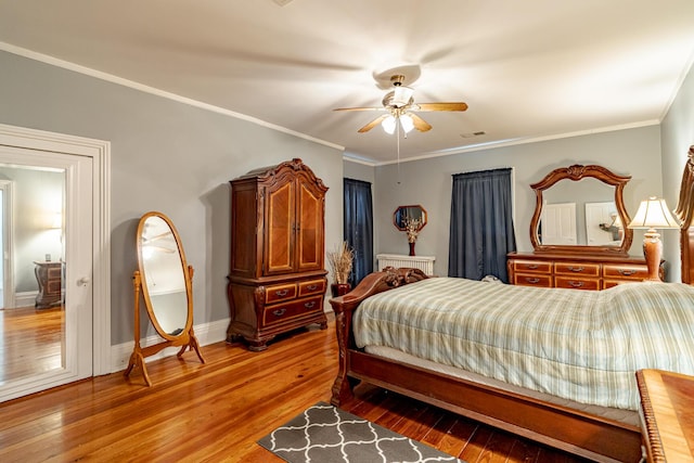 bedroom featuring crown molding, hardwood / wood-style floors, and ceiling fan