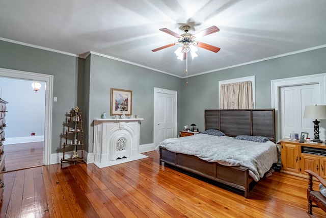 bedroom with light wood-type flooring, ceiling fan, and ornamental molding