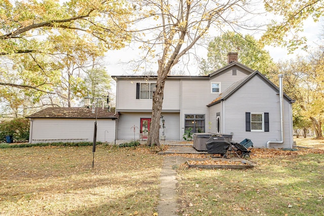 rear view of house featuring a yard