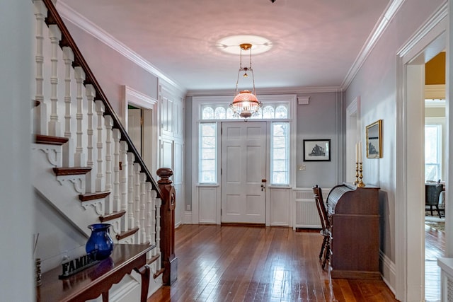 entrance foyer with hardwood / wood-style flooring and ornamental molding