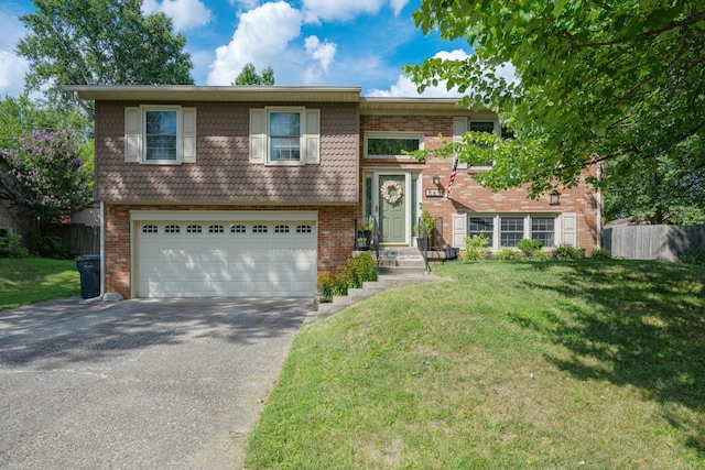 raised ranch featuring a garage and a front yard