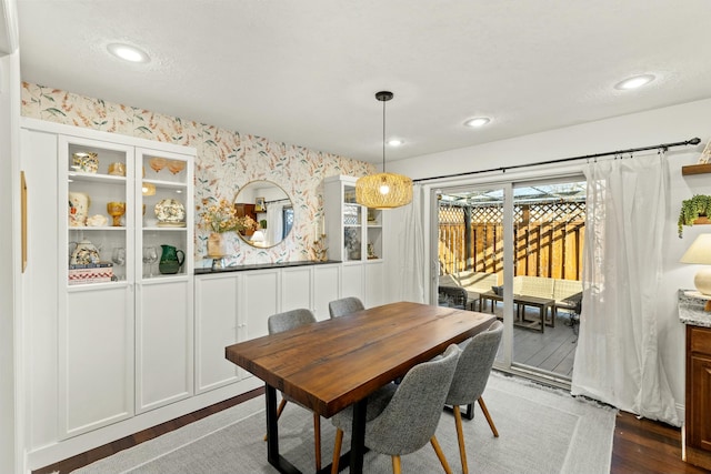 dining space with dark wood-type flooring and a textured ceiling