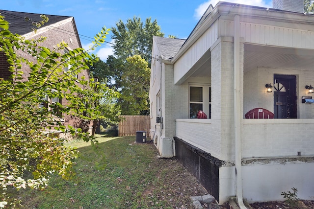 view of property exterior featuring a yard and central AC