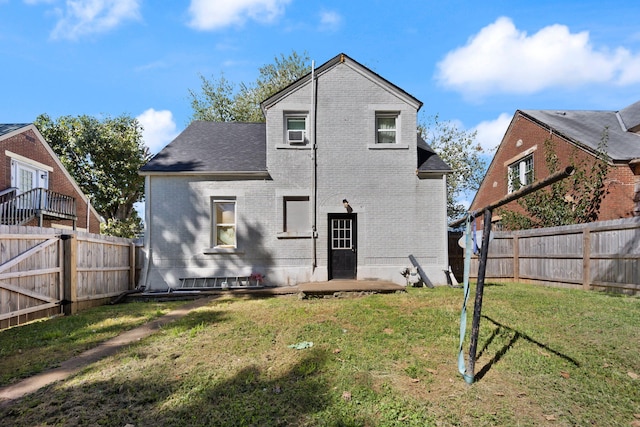 back of house featuring a lawn