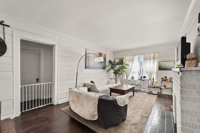 living room with ornamental molding and dark hardwood / wood-style floors