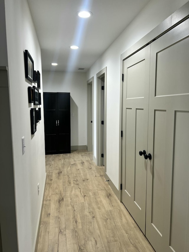 corridor with light wood-type flooring