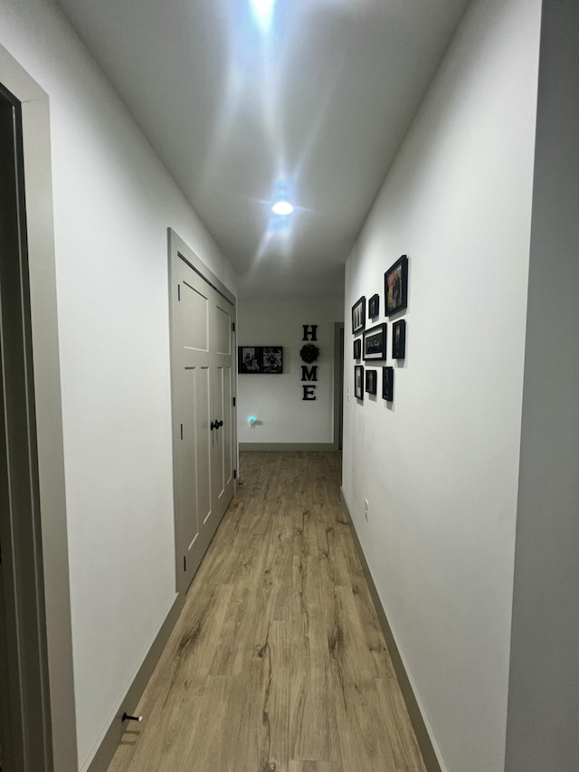 hallway with light hardwood / wood-style flooring