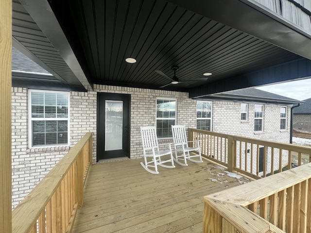 wooden deck featuring ceiling fan