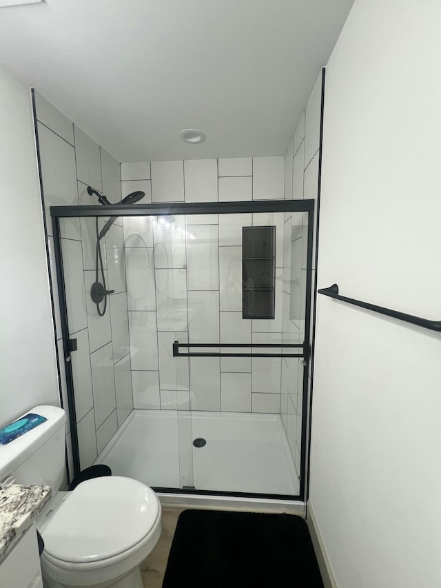 bathroom with vanity, toilet, and walk in shower