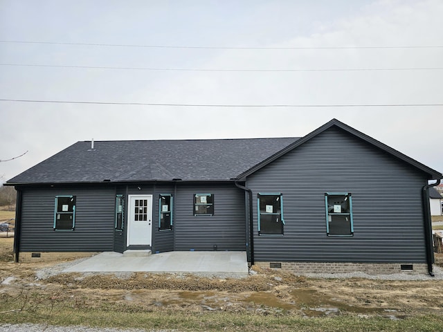 view of front of property with entry steps, crawl space, roof with shingles, and a patio