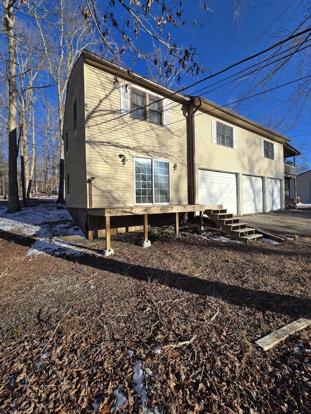 back of property with a garage