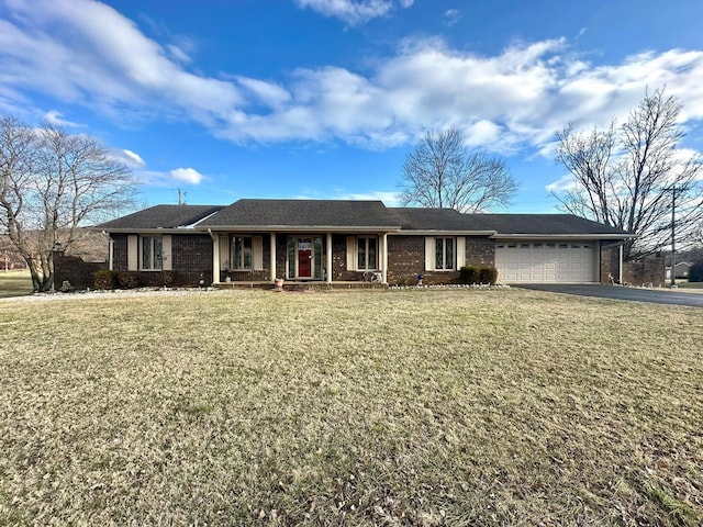 ranch-style house featuring a front lawn, brick siding, driveway, and an attached garage