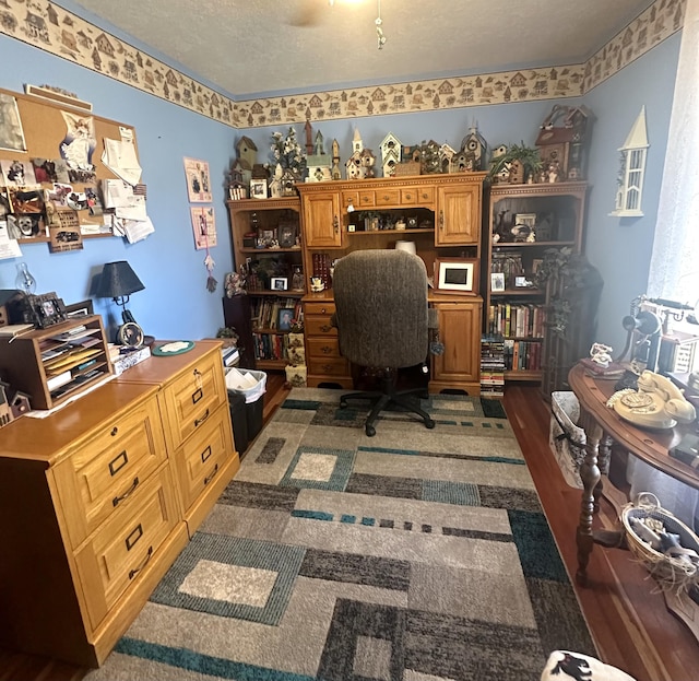 office featuring dark hardwood / wood-style flooring and a textured ceiling