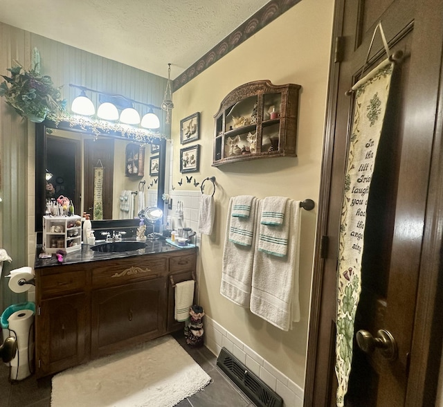 bathroom featuring vanity and a textured ceiling