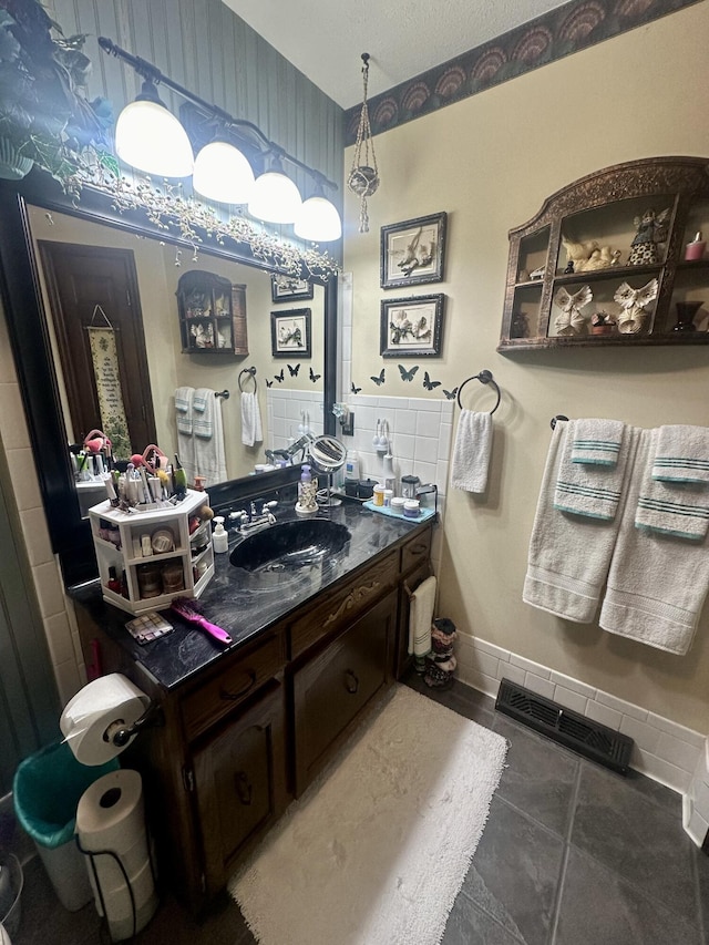 bathroom featuring tile patterned flooring and vanity