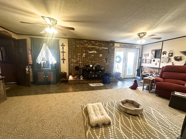 living room featuring tile patterned flooring, ceiling fan, a textured ceiling, and french doors