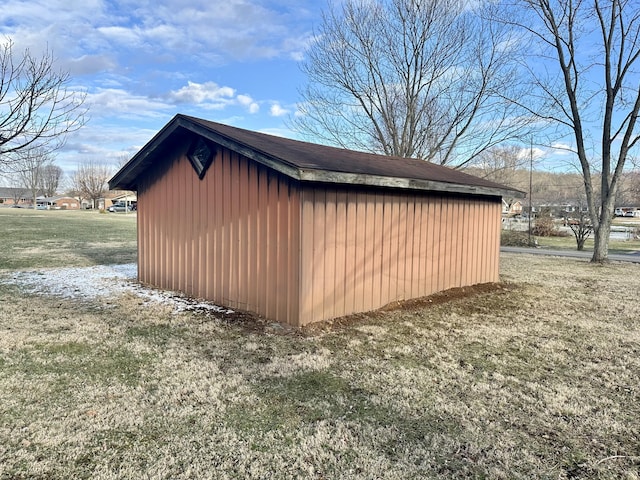 view of outbuilding featuring a lawn