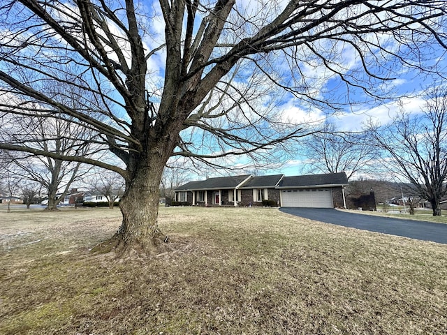 view of front of property with a garage and a front yard