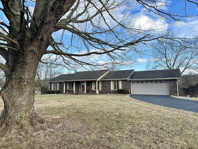 ranch-style home with a garage and a front lawn