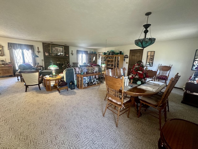 carpeted dining room with a textured ceiling and a fireplace