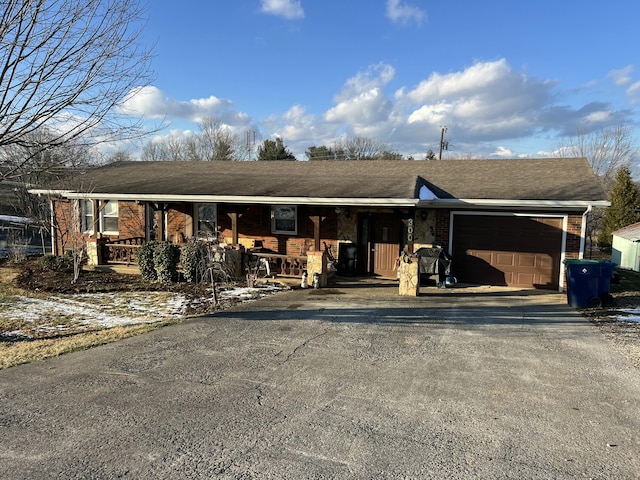 view of front of home featuring covered porch and a garage