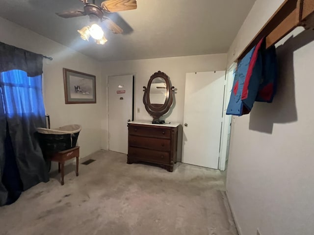 interior space with ceiling fan and light carpet