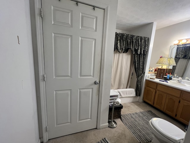 bathroom with toilet, a textured ceiling, and vanity