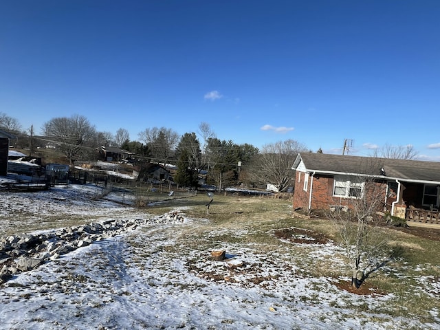 view of yard layered in snow