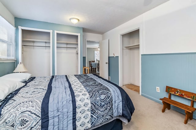 carpeted bedroom with multiple closets