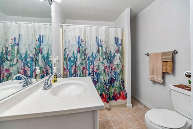 bathroom with vanity, toilet, curtained shower, and tile patterned flooring