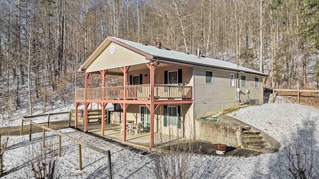 exterior space with a deck, cooling unit, and a patio