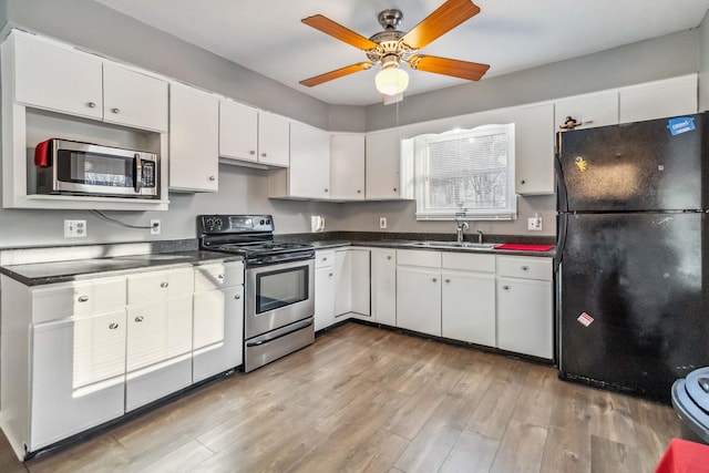 kitchen with light hardwood / wood-style floors, sink, white cabinetry, and stainless steel appliances