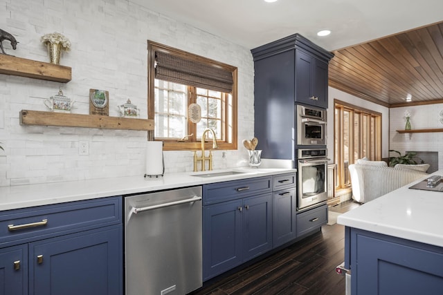 kitchen with dark wood-type flooring, blue cabinets, sink, wood ceiling, and appliances with stainless steel finishes