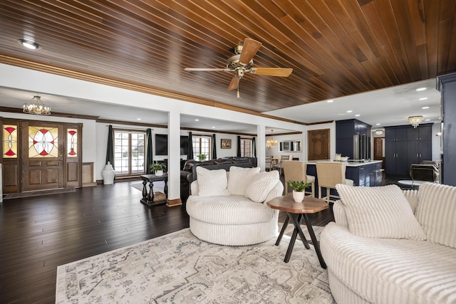 living room featuring ornamental molding, dark hardwood / wood-style floors, ceiling fan with notable chandelier, and wooden ceiling