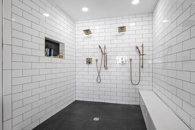 bathroom with tile patterned flooring and tiled shower