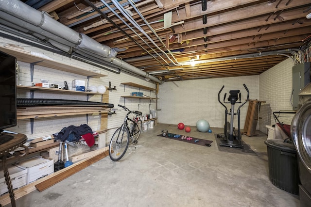 basement with electric panel and a workshop area