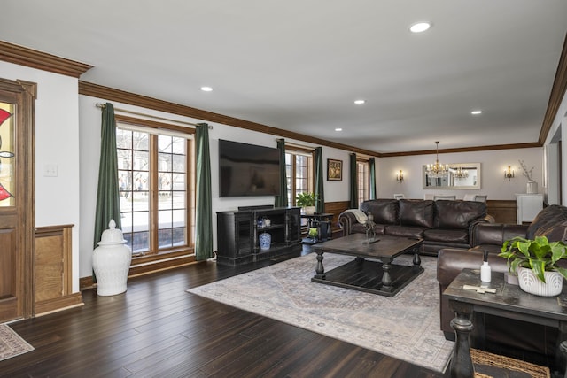 living room with ornamental molding, dark wood-type flooring, and a notable chandelier